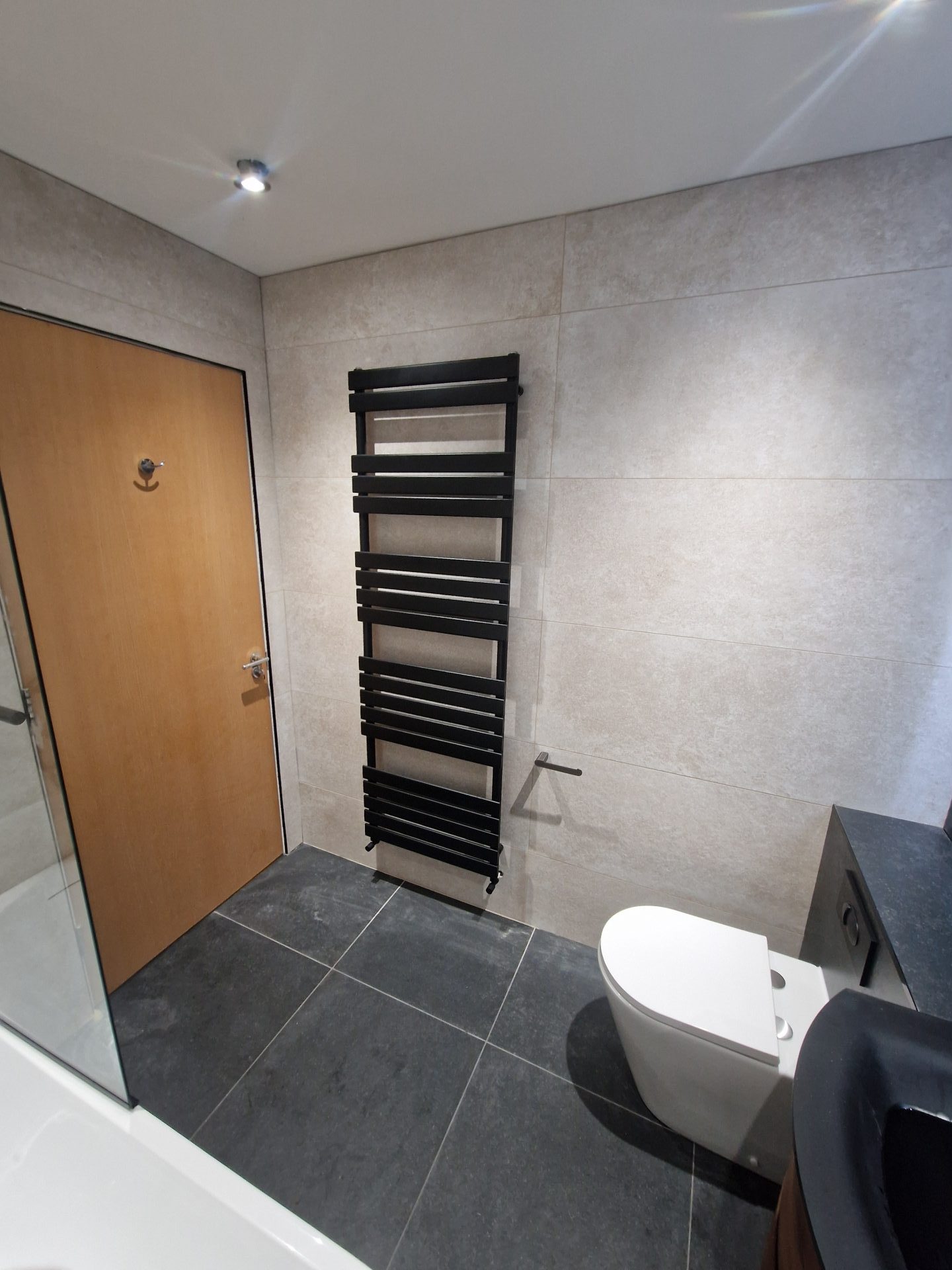 Bathroom with a black heated towel rail and modern fixtures