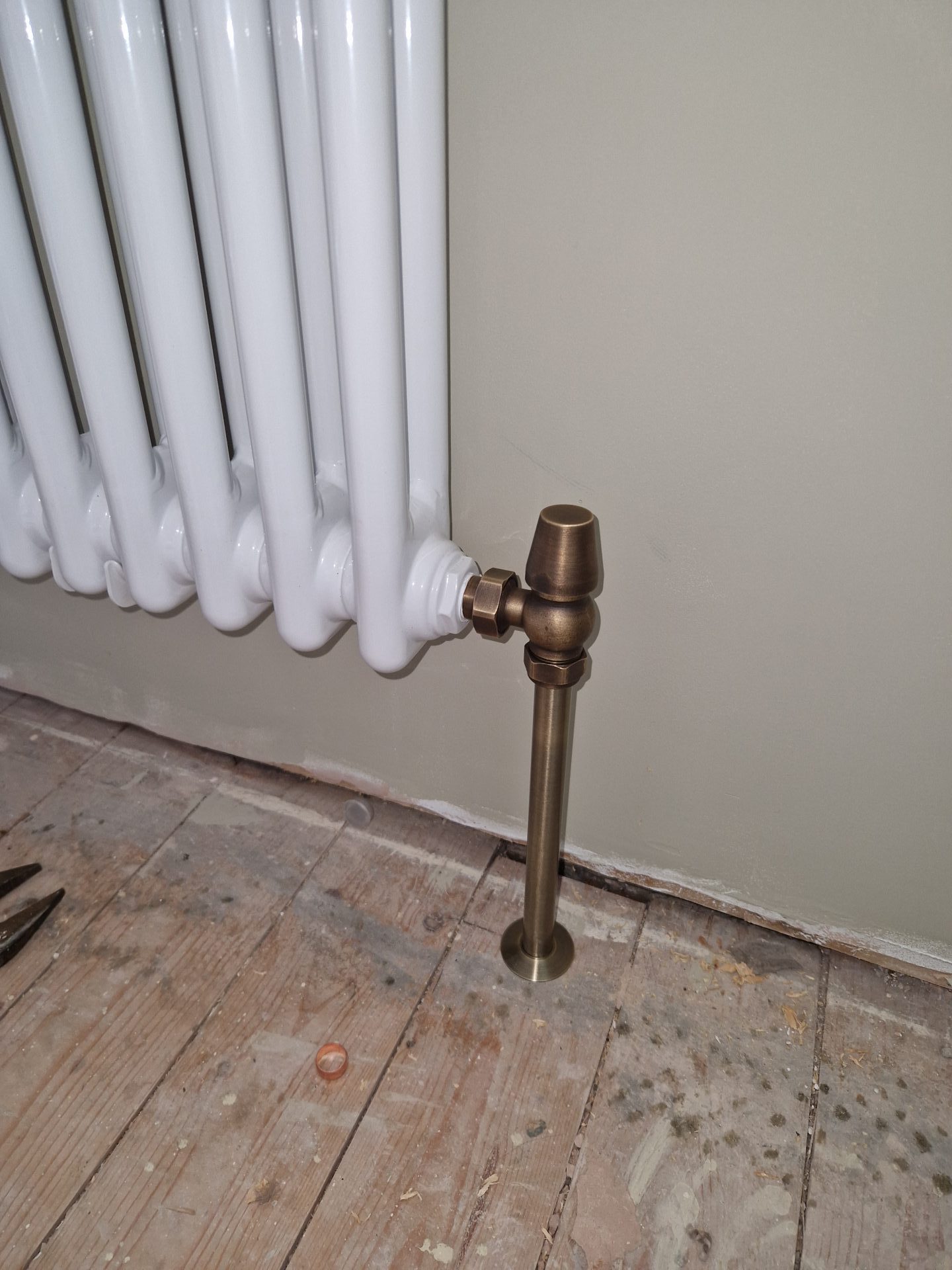 Close-up of a radiator valve with brass fittings